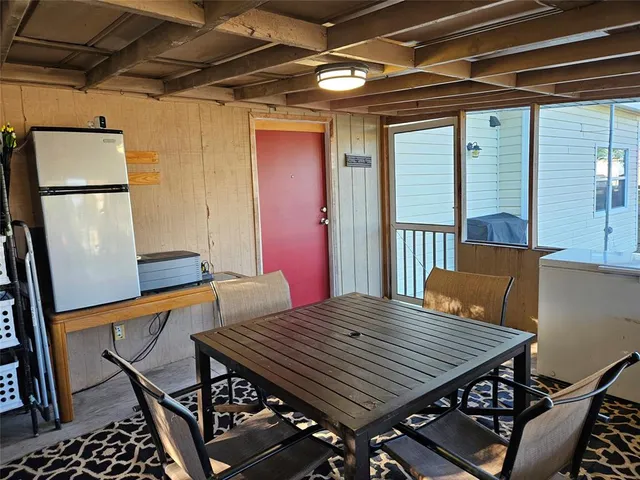 a view of a balcony dining area with furniture