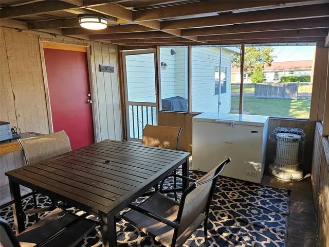 a view of a wooden chairs and table in the patio