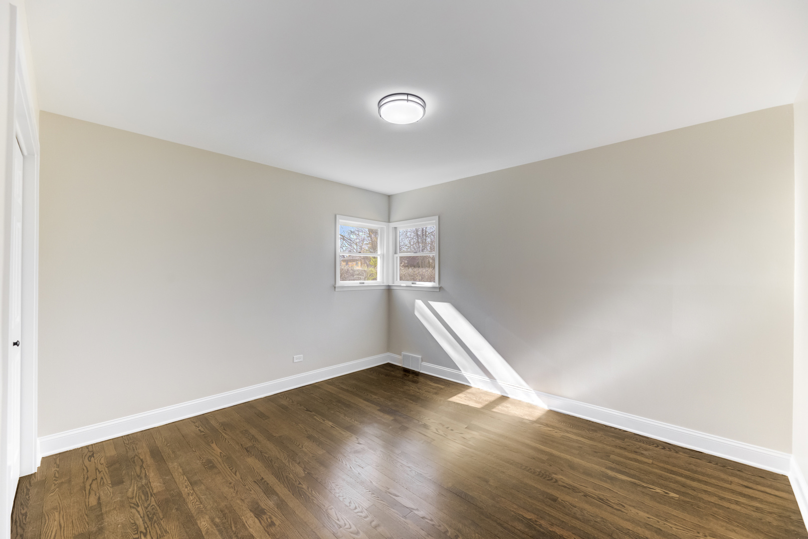 4701 Wolf Road Western Springs, IL 60558 - Photo 11 of 27 an empty room with wooden floor and windows