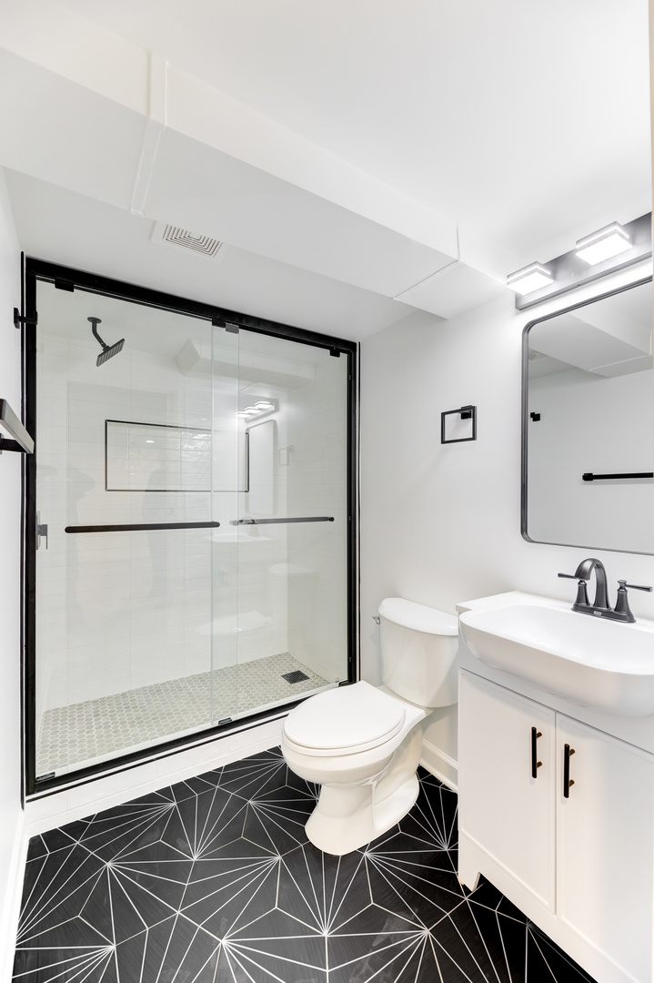 4701 Wolf Road Western Springs, IL 60558 - Photo 15 of 27 a bathroom with a sink toilet a mirror and shower