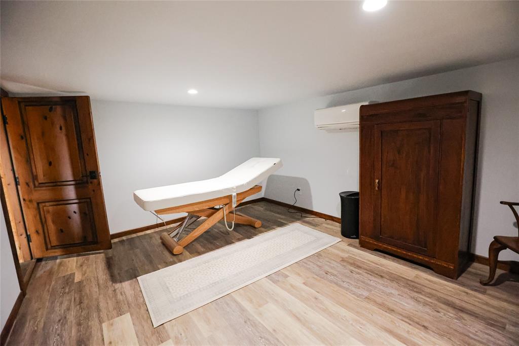 1250 County Road Brady, TX 76825 - Photo 27 of 40 a room with wooden floor and furniture