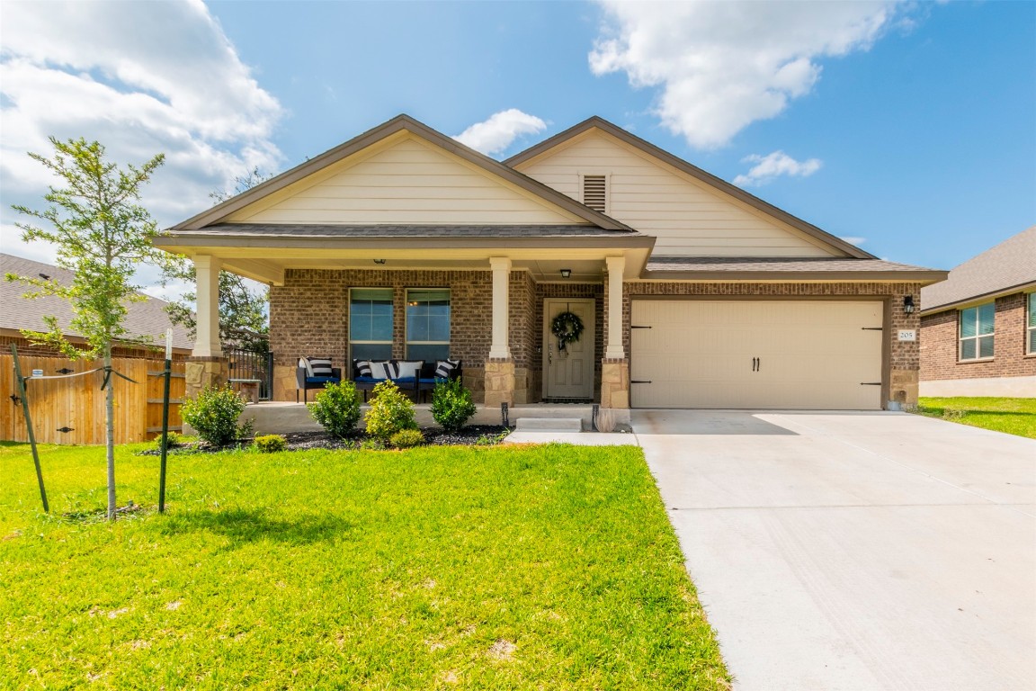 205 Pepper Mill Loop Burnet, TX 78611 - Photo 1 of 25 a view of a house with sitting area and garden