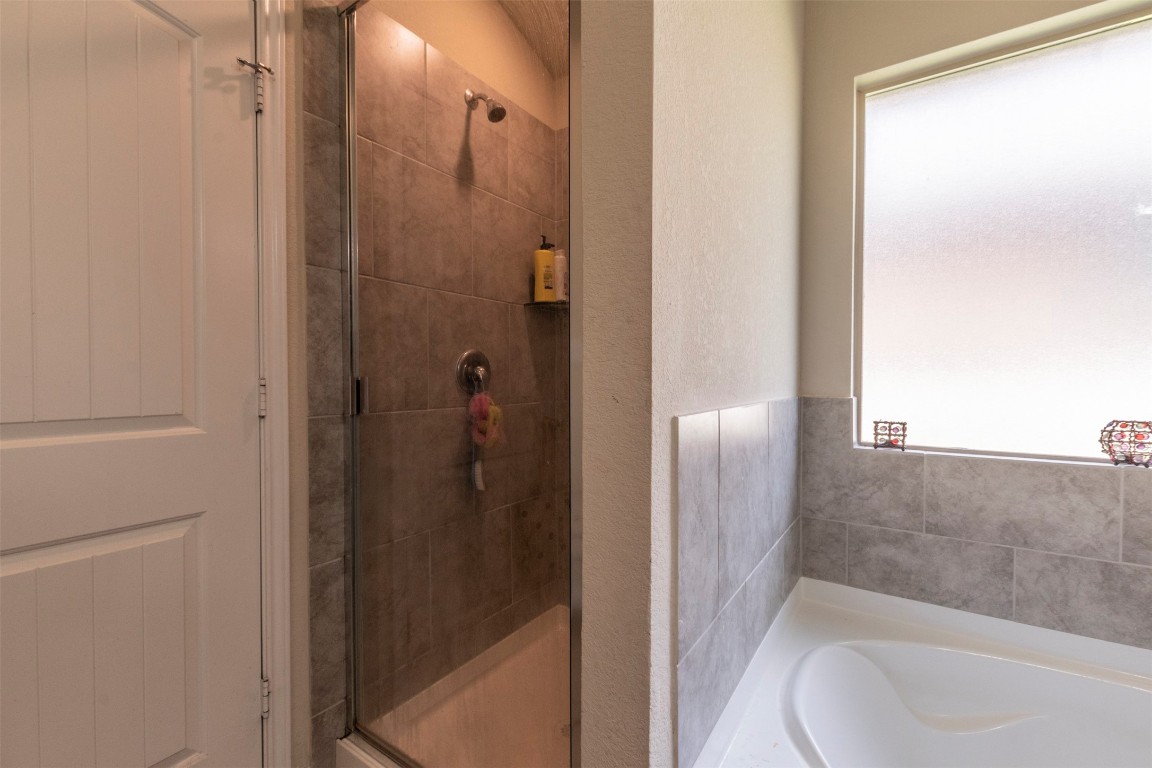 205 Pepper Mill Loop Burnet, TX 78611 - Photo 11 of 25 a bathroom with a tub and shower