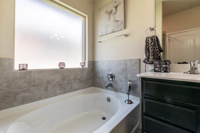 a bathroom with a bathtub and sink