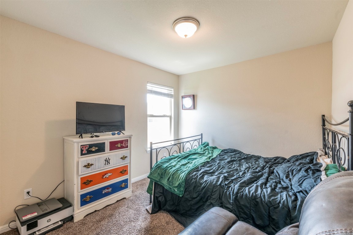 205 Pepper Mill Loop Burnet, TX 78611 - Photo 15 of 25 a bedroom with a bed and a flat screen tv