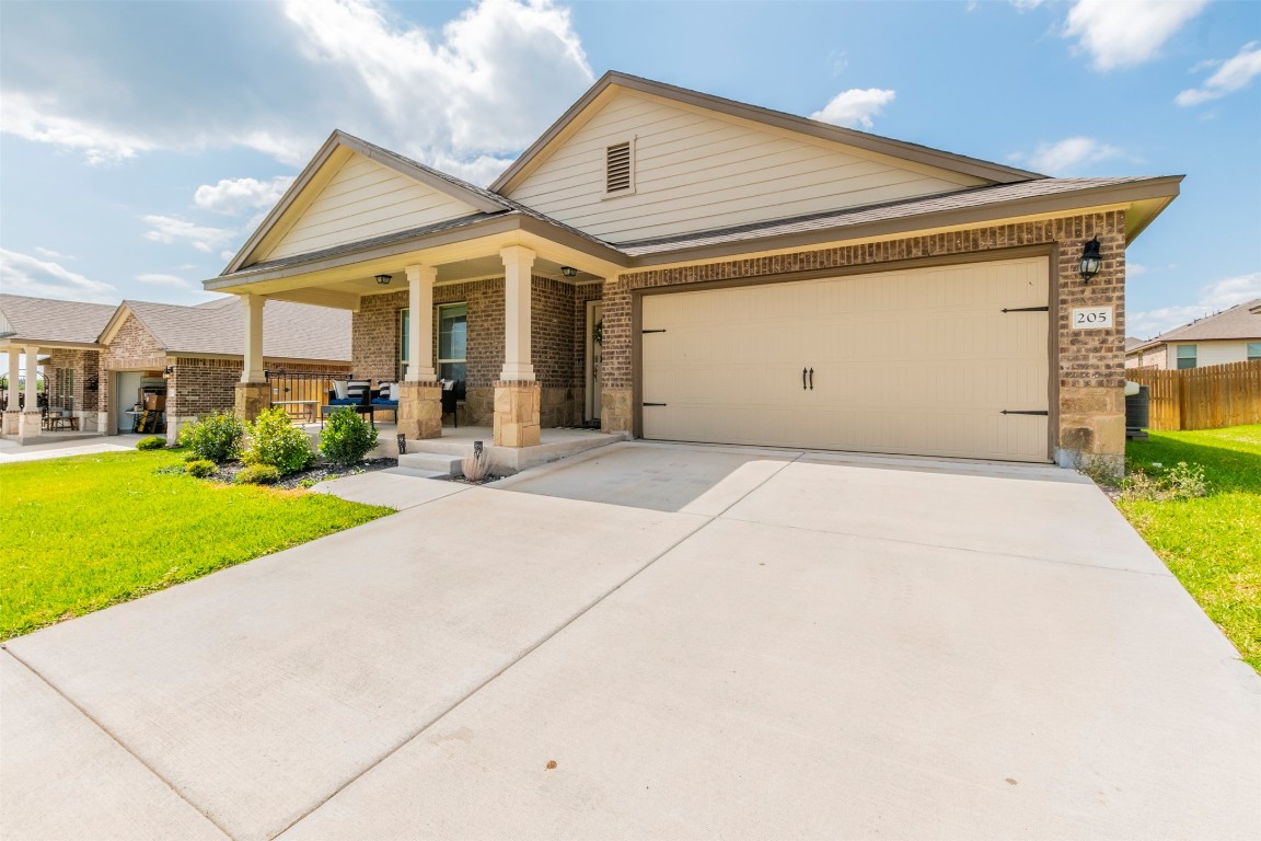 205 Pepper Mill Loop Burnet, TX 78611 - Photo 20 of 25 a front view of a house with a yard and porch