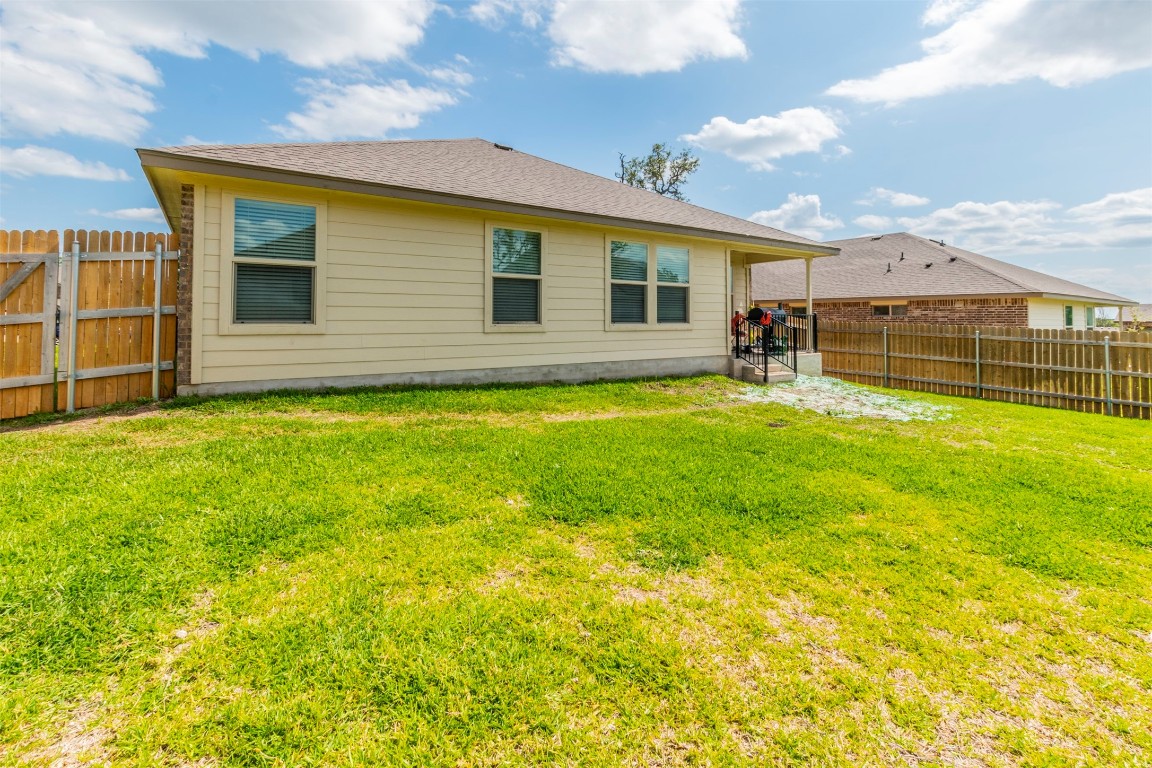205 Pepper Mill Loop Burnet, TX 78611 - Photo 25 of 25 a backyard of a house with table and chairs