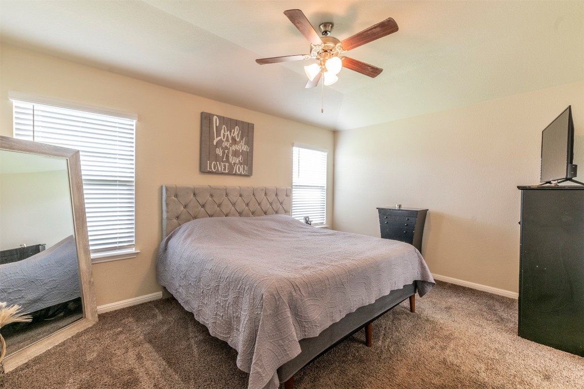 205 Pepper Mill Loop Burnet, TX 78611 - Photo 8 of 25 a bedroom with a bed a couch and a window