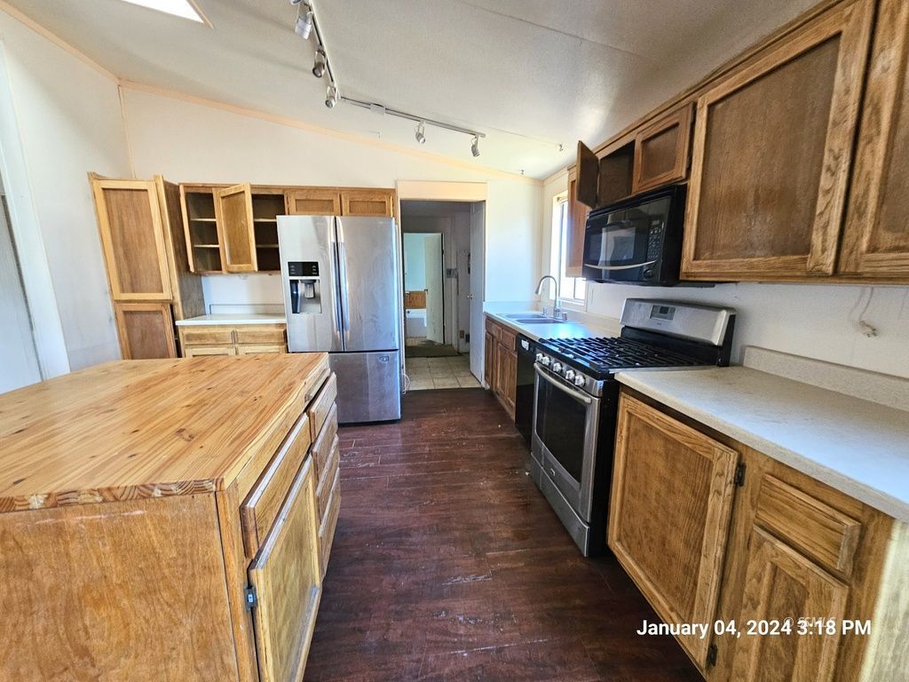 1330 North Pluto Street Ridgecrest, CA 93555 - Photo 6 of 32 a kitchen with stainless steel appliances granite countertop a refrigerator a stove top oven a sink and dishwasher