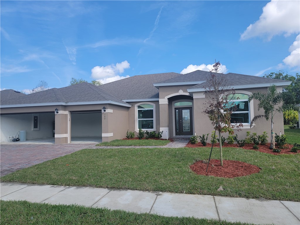 107 52nd Square Vero Beach, FL 32968 - Photo 1 of 20 a front view of a house with a yard and garage