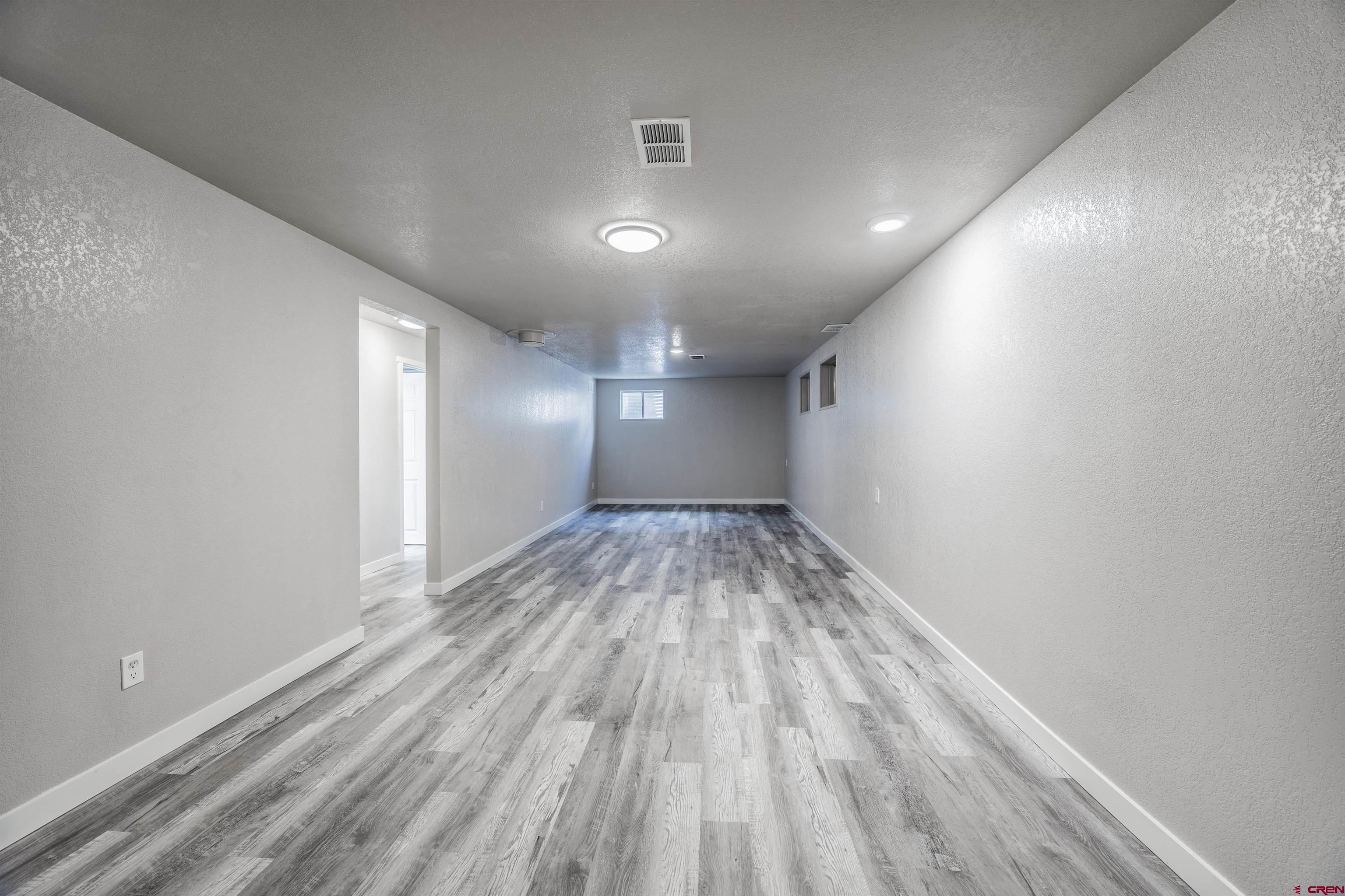 2130 Devon Street Montrose, CO 81401 - Photo 12 of 27 a view of empty room with wooden floor