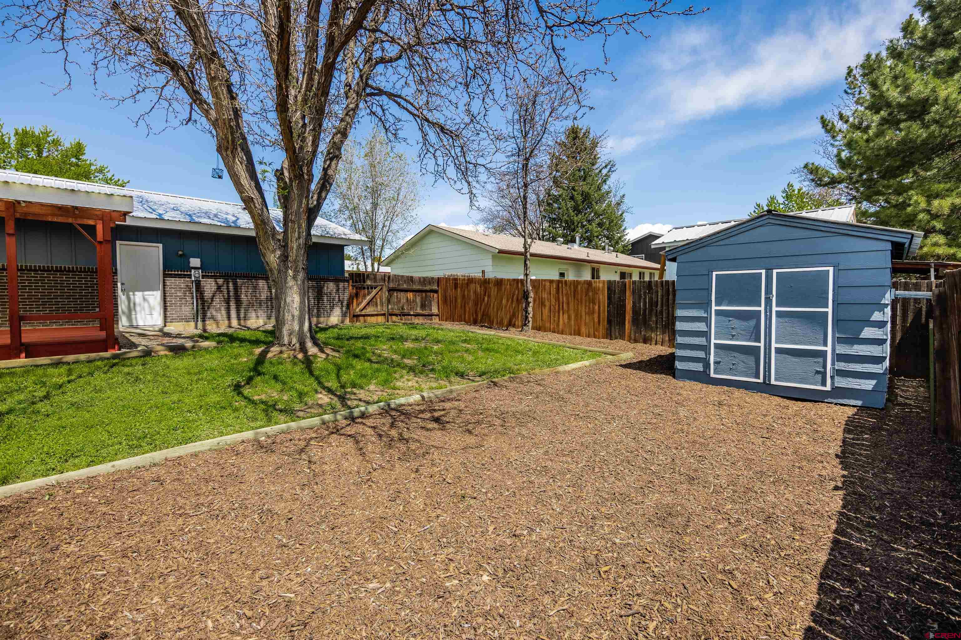 2130 Devon Street Montrose, CO 81401 - Photo 19 of 27 a front view of a house with a yard and garage