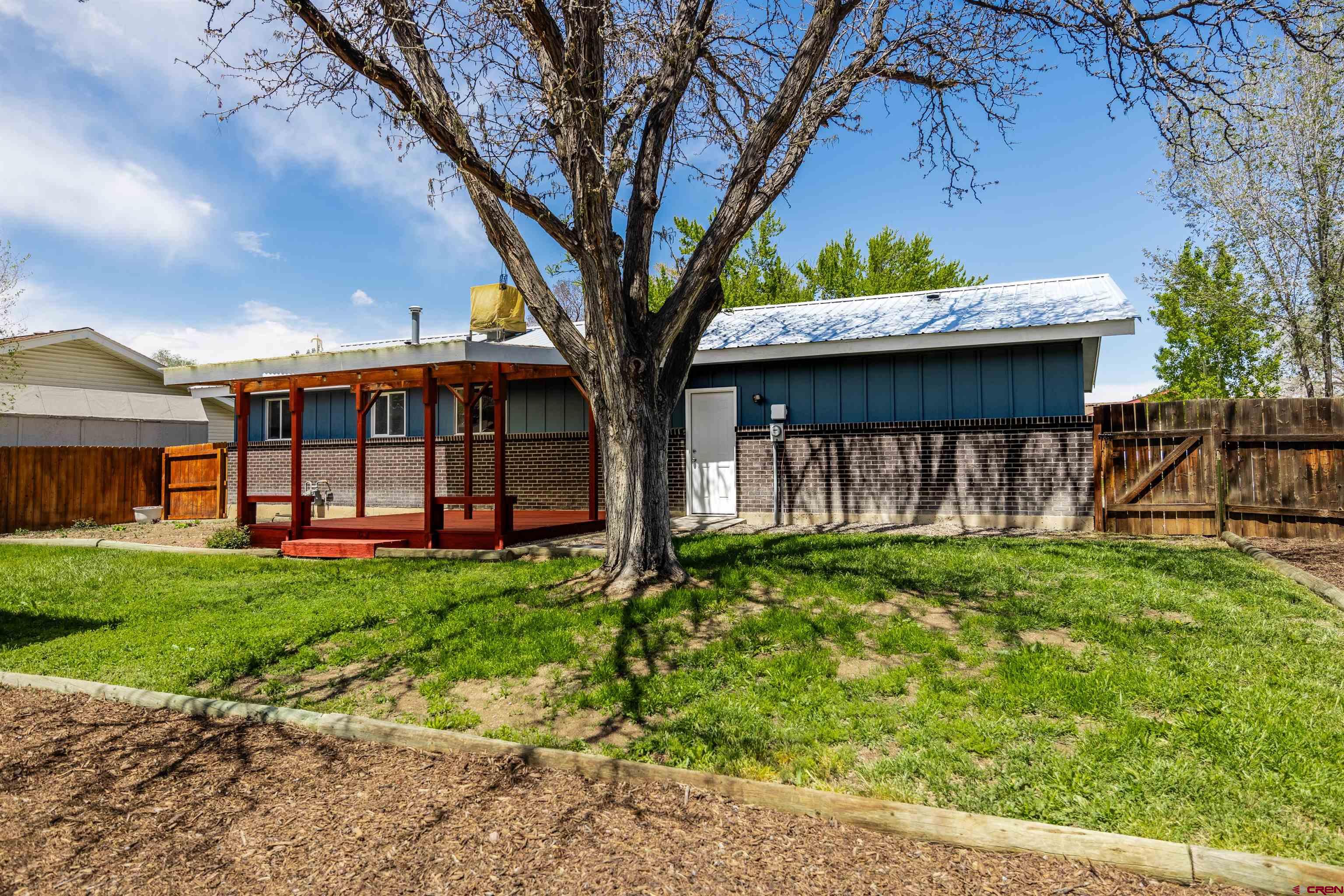 2130 Devon Street Montrose, CO 81401 - Photo 22 of 27 a view of a house with backyard and sitting area