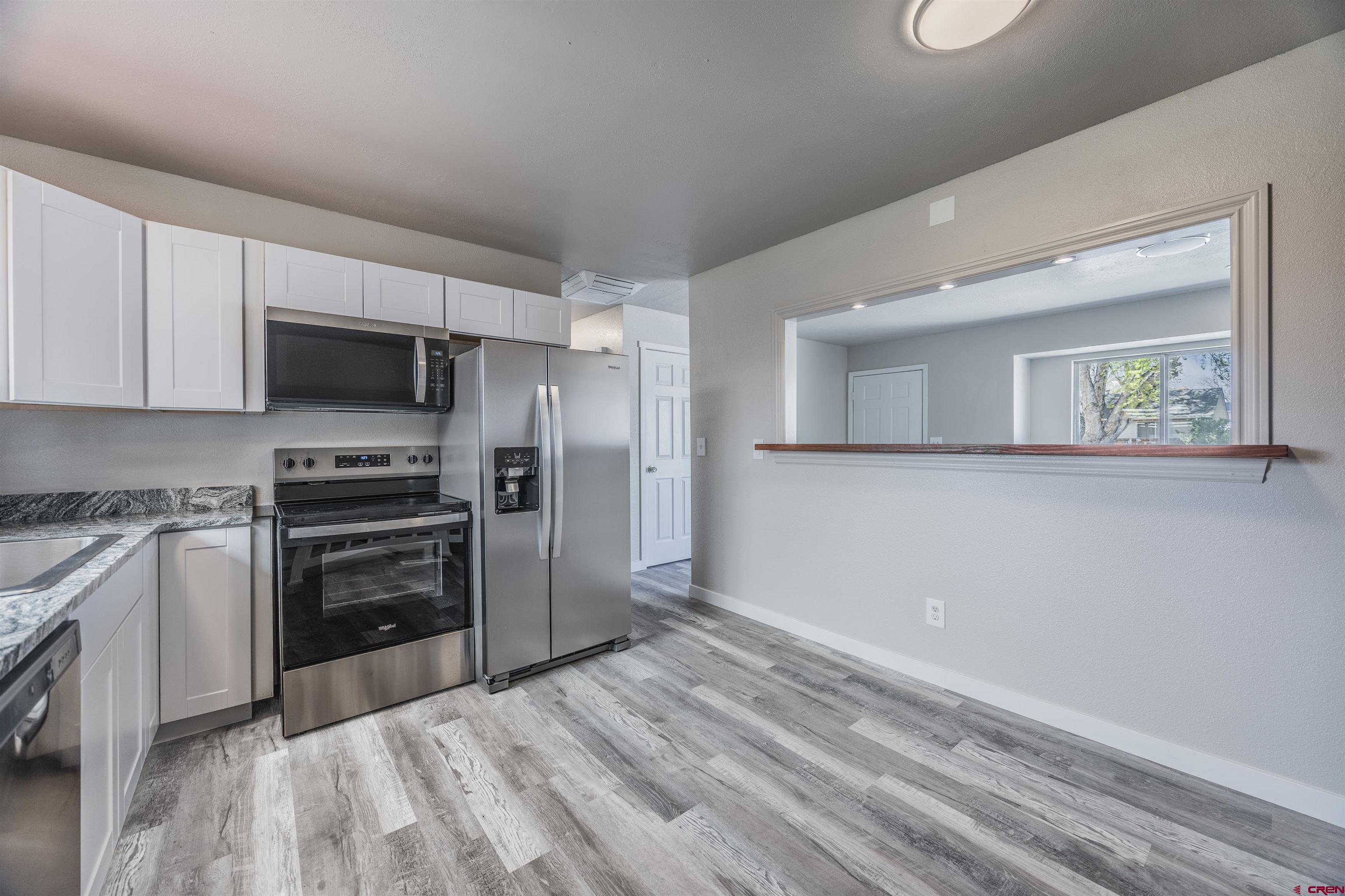 2130 Devon Street Montrose, CO 81401 - Photo 7 of 27 a kitchen with a refrigerator stove and microwave