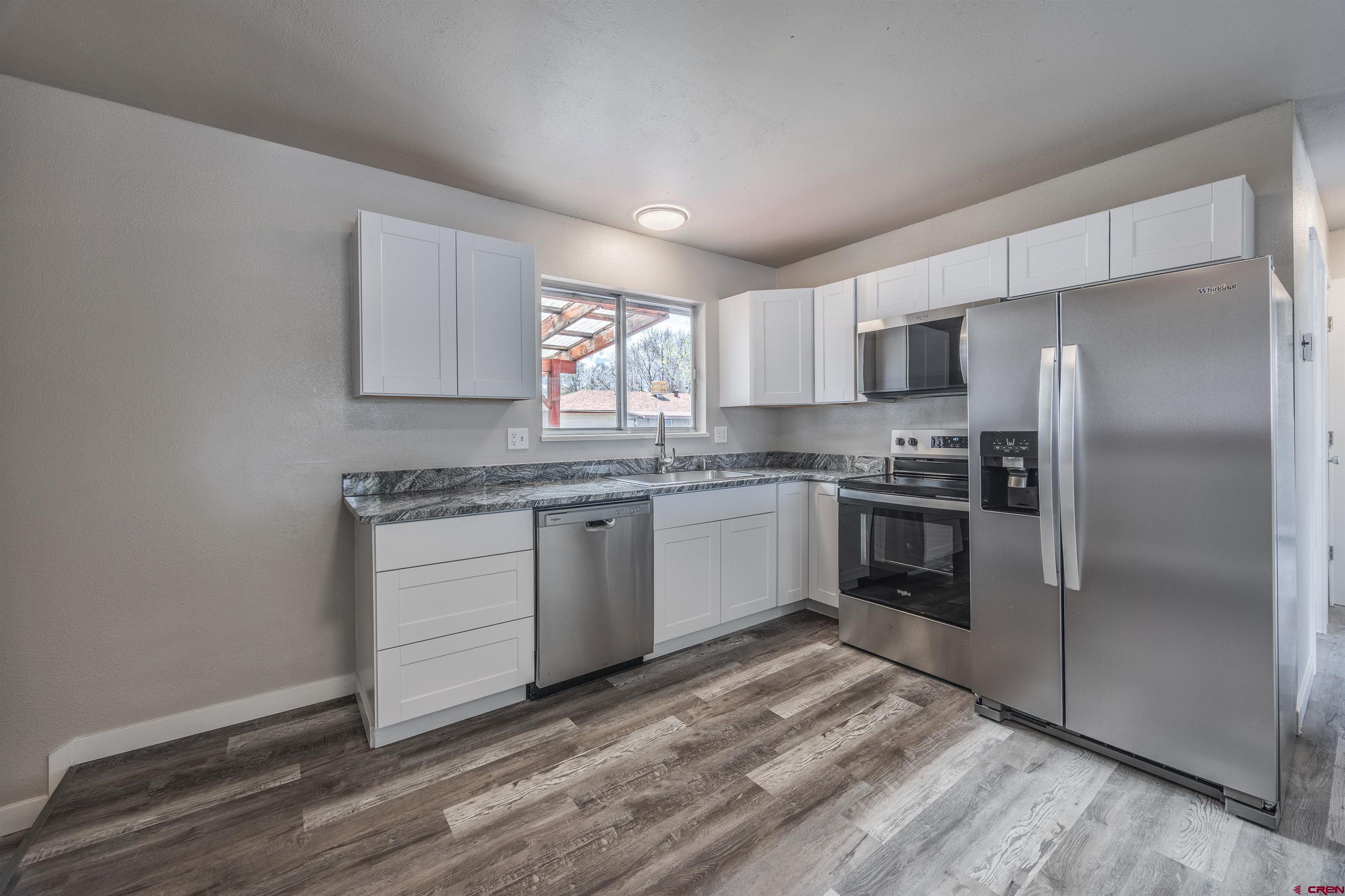 2130 Devon Street Montrose, CO 81401 - Photo 8 of 27 a kitchen with a refrigerator stove and microwave