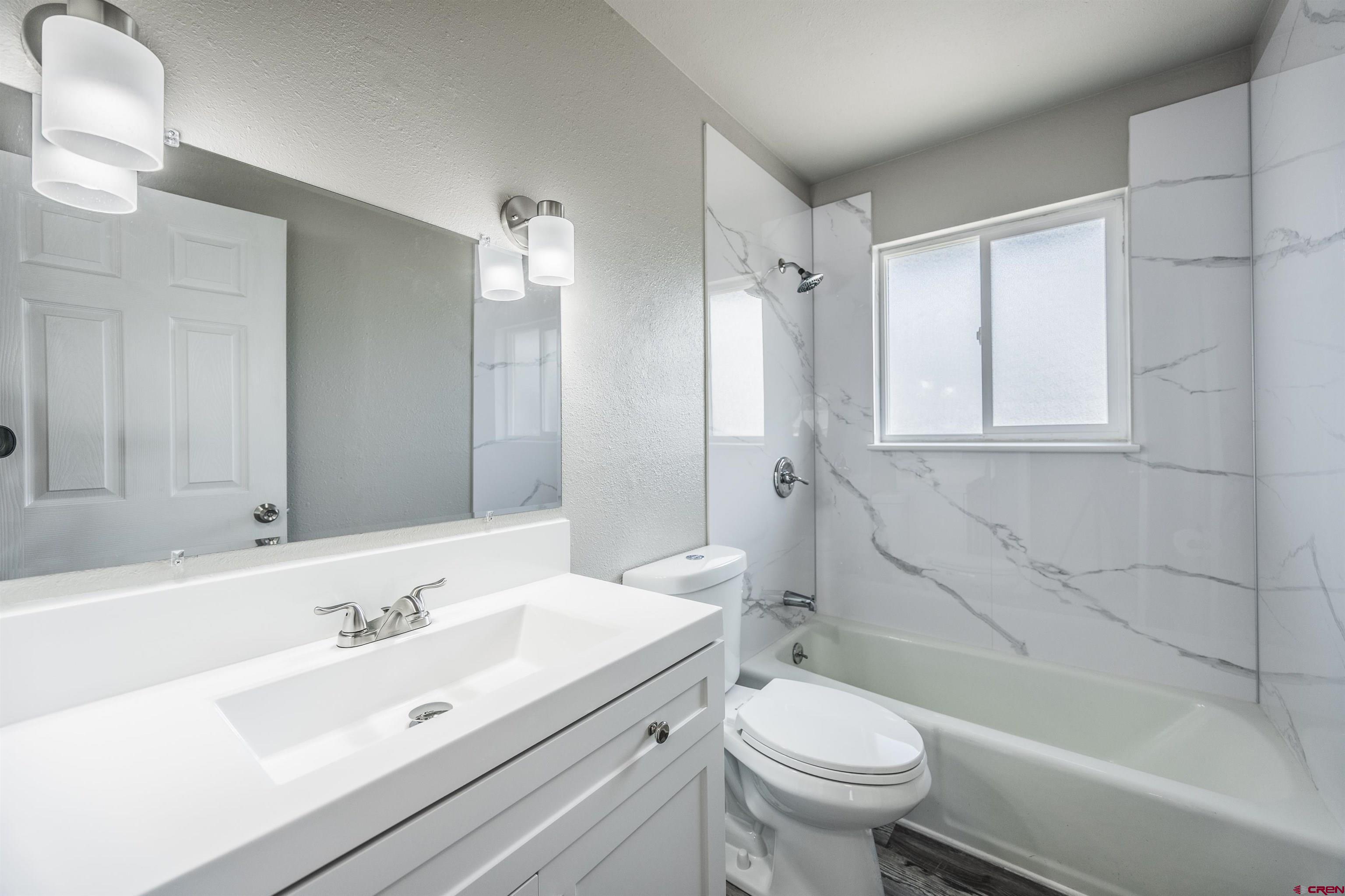2130 Devon Street Montrose, CO 81401 - Photo 9 of 27 a bathroom with a sink a toilet and shower