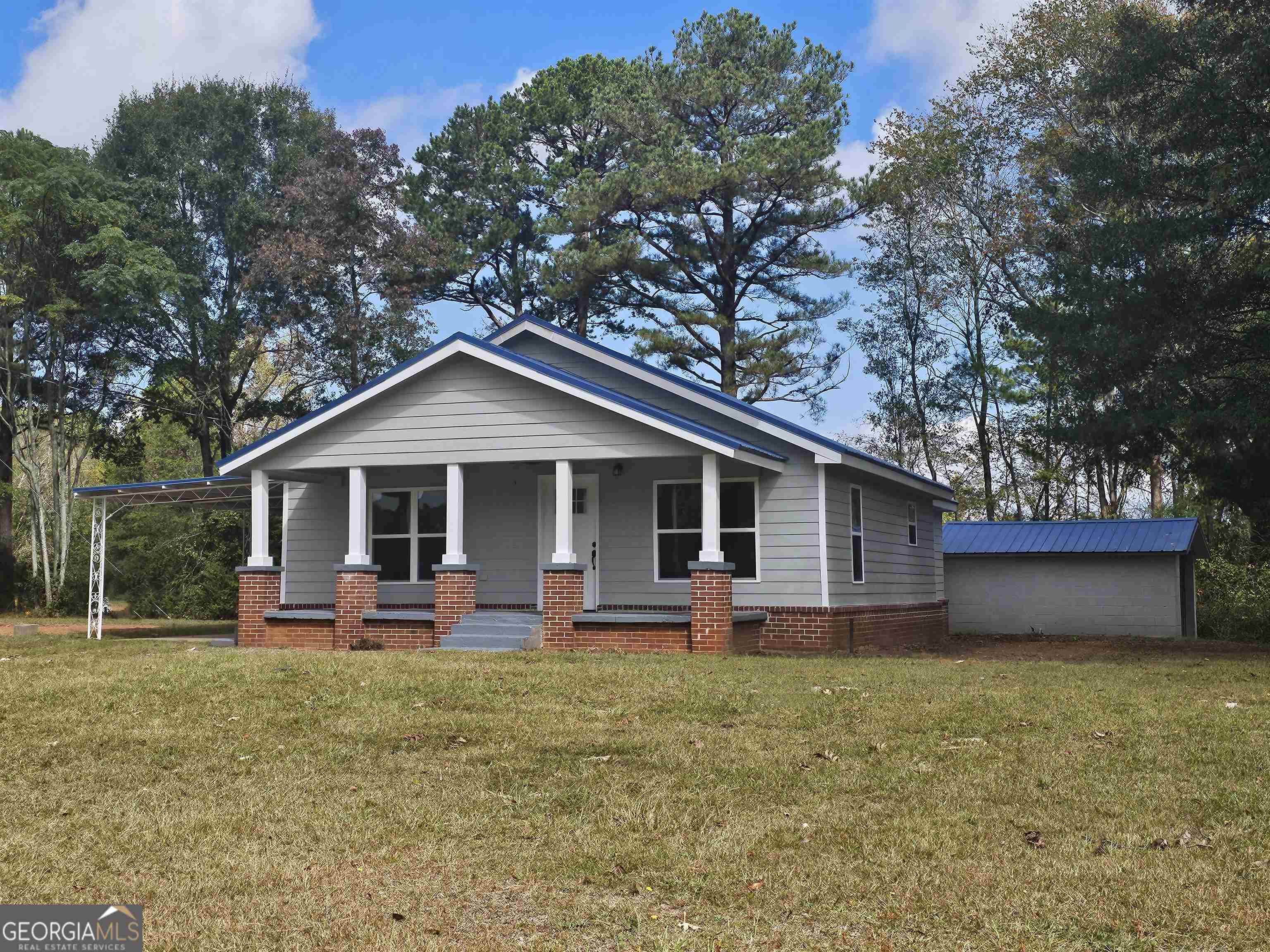 406 Doster Road Jefferson, GA 30549 - Photo 1 of 1 a front view of house with yard and green space