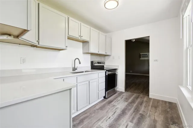 a kitchen with white cabinets and a stove