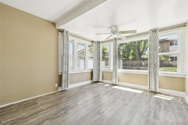 wooden floor in an empty room with a window