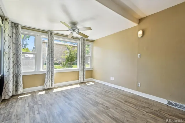 a view of deck with wooden floor and fence with a floor to ceiling window