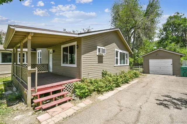 a house with green field in front of it