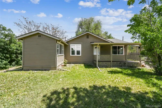 a backyard of a house with table and chairs