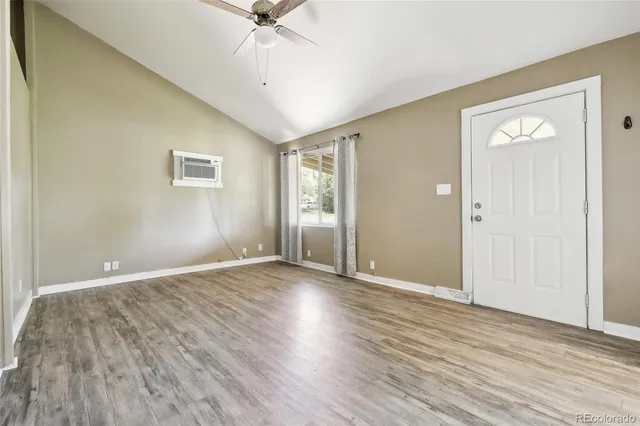 wooden floor in an empty room with a window