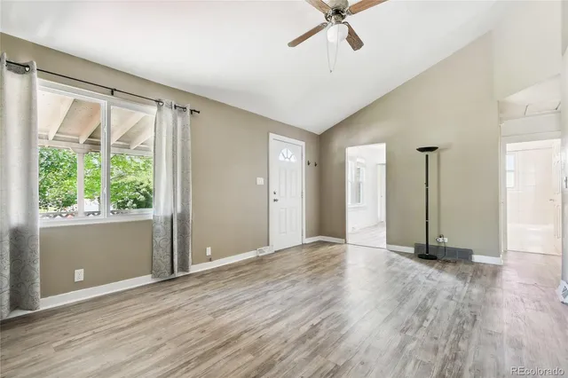 wooden floor in an empty room with a window