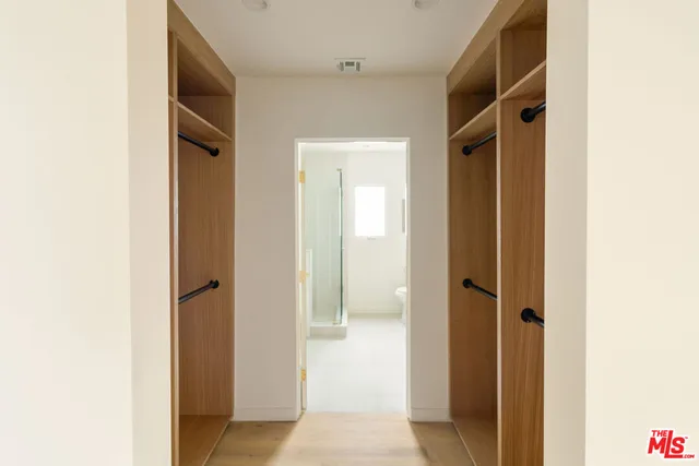 a bathroom with double vanity sink a mirror and a toilet