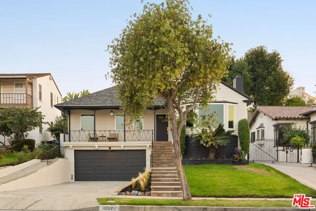 a view of a porch with furniture and floor to ceiling window