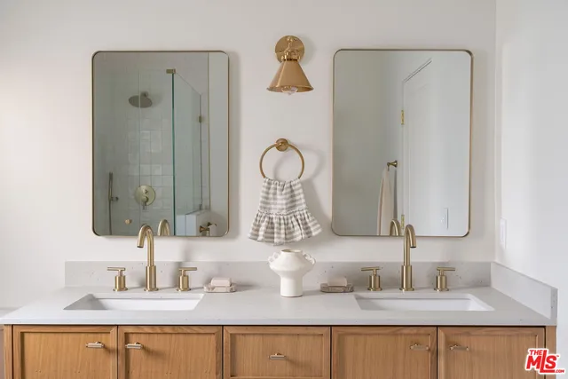 a bathroom with a toilet a sink a and mirror
