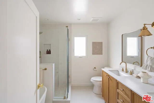 a white bath tub sitting next to a shower