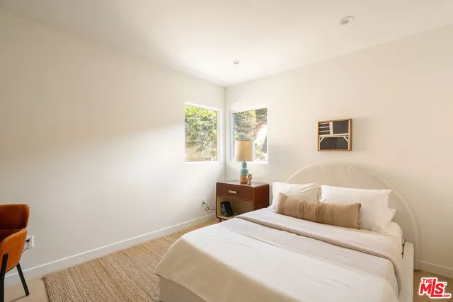 a bedroom with a bed and a table