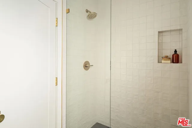 a bathroom with a glass shower door