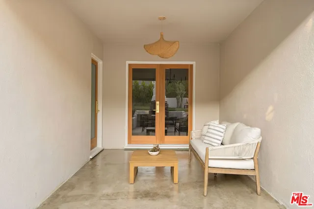 a living room with furniture a fireplace and a large window