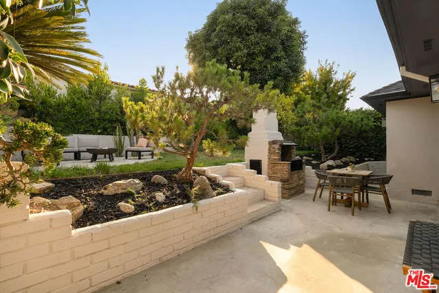 a view of backyard with outdoor seating and green space