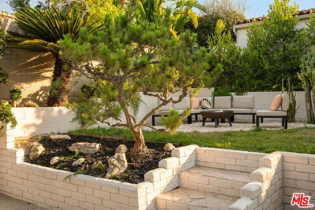 a backyard of a house with table and chairs