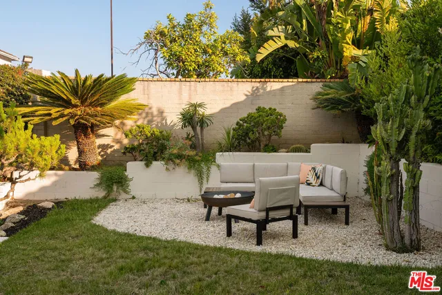 a view of a backyard with sitting area
