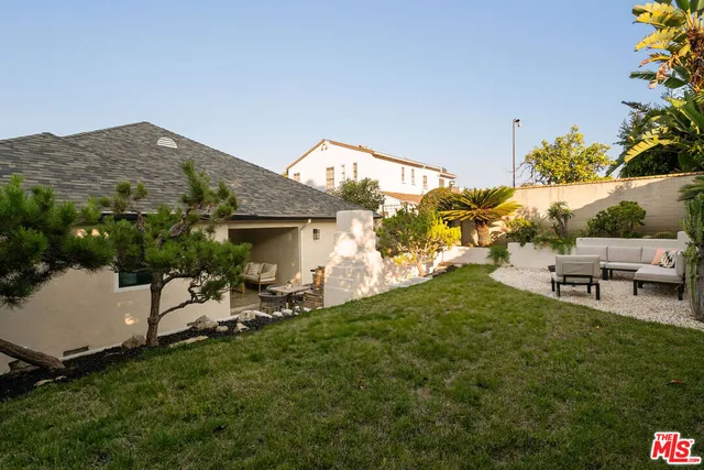 a backyard of a house with outdoor seating