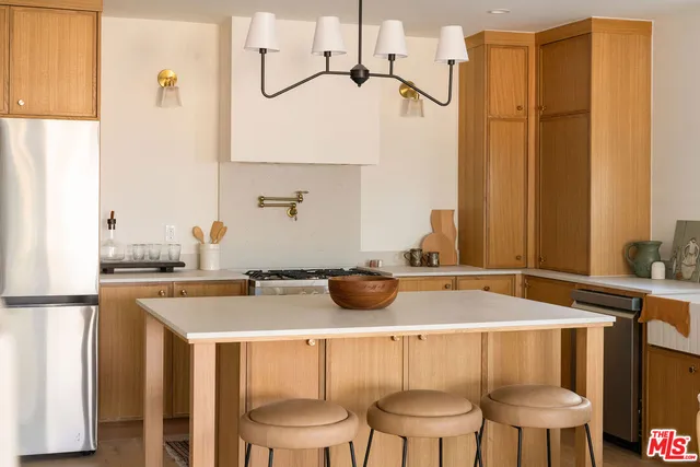 a kitchen with a stove a sink and a refrigerator