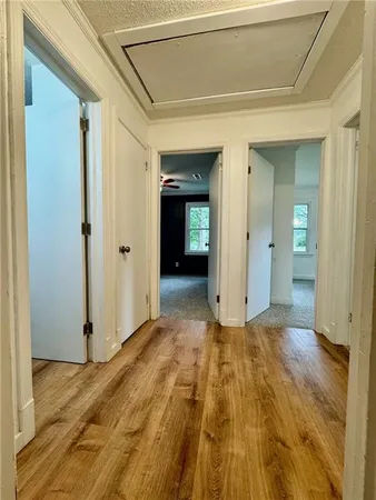 a view of a room with wooden floor and brick wall