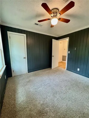 en empty room with windows and fan