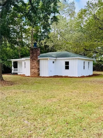 a front view of house with pool and yard