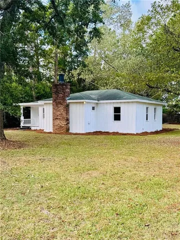 a front view of house with pool and yard
