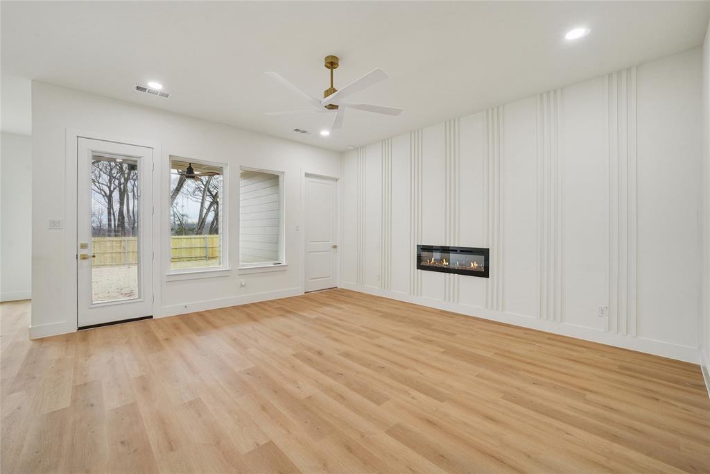 1147 Riverwood Road Dallas, TX 75217 - Photo 13 of 26 a view of an empty room with wooden floor and cabinet