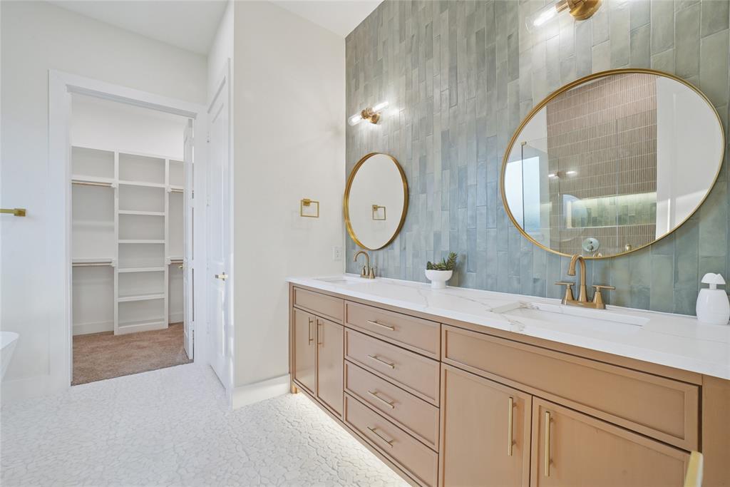 1147 Riverwood Road Dallas, TX 75217 - Photo 16 of 26 a bathroom with a double vanity sink and a mirror