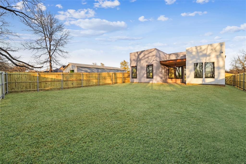 1147 Riverwood Road Dallas, TX 75217 - Photo 20 of 26 a view of a house with a big yard and large trees