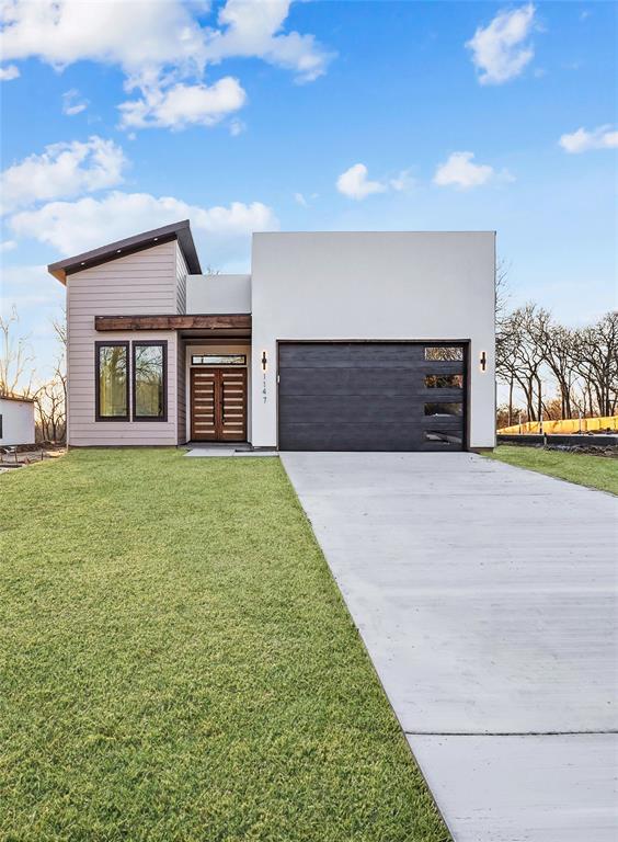 1147 Riverwood Road Dallas, TX 75217 - Photo 23 of 26 a view of a house with a yard and garage