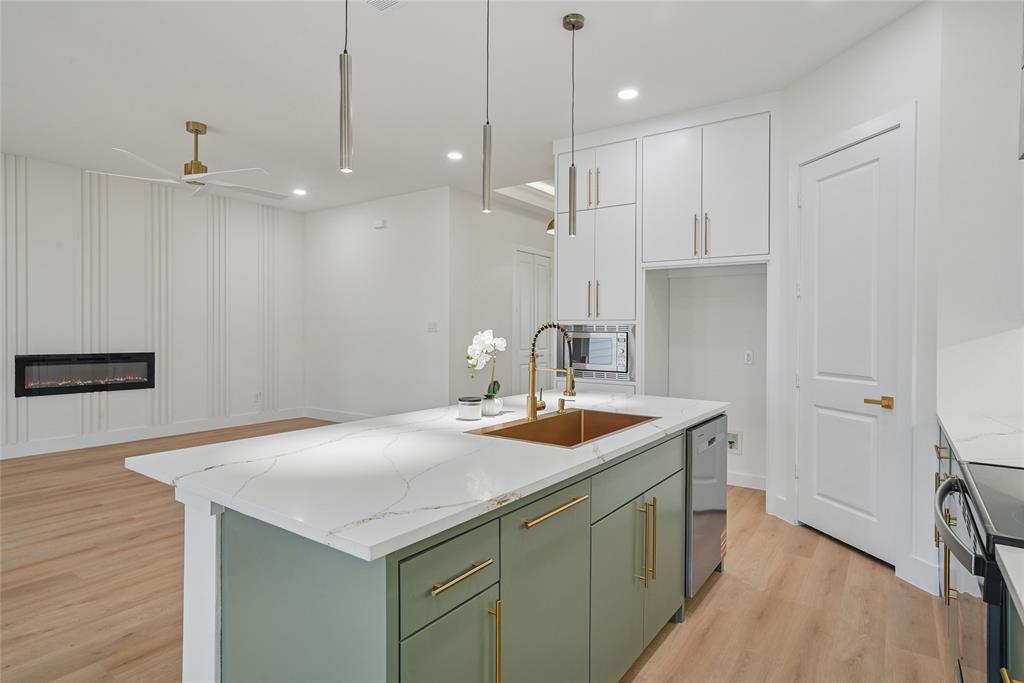 1147 Riverwood Road Dallas, TX 75217 - Photo 7 of 26 a kitchen with stainless steel appliances granite countertop a sink a refrigerator and a stove