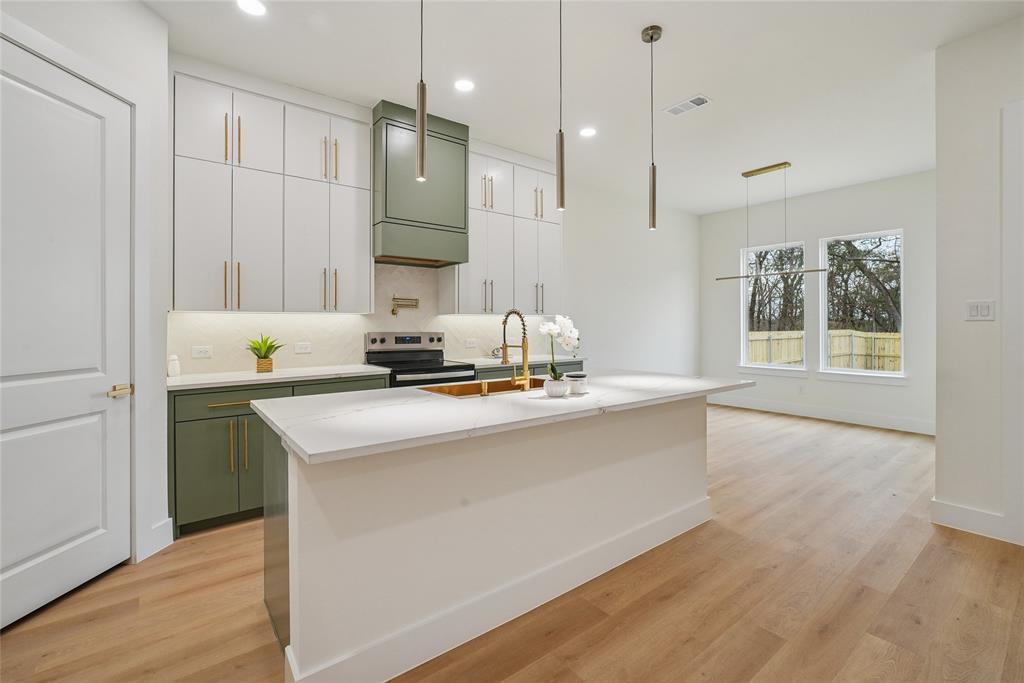 1147 Riverwood Road Dallas, TX 75217 - Photo 8 of 26 a kitchen with kitchen island granite countertop a sink appliances and cabinets